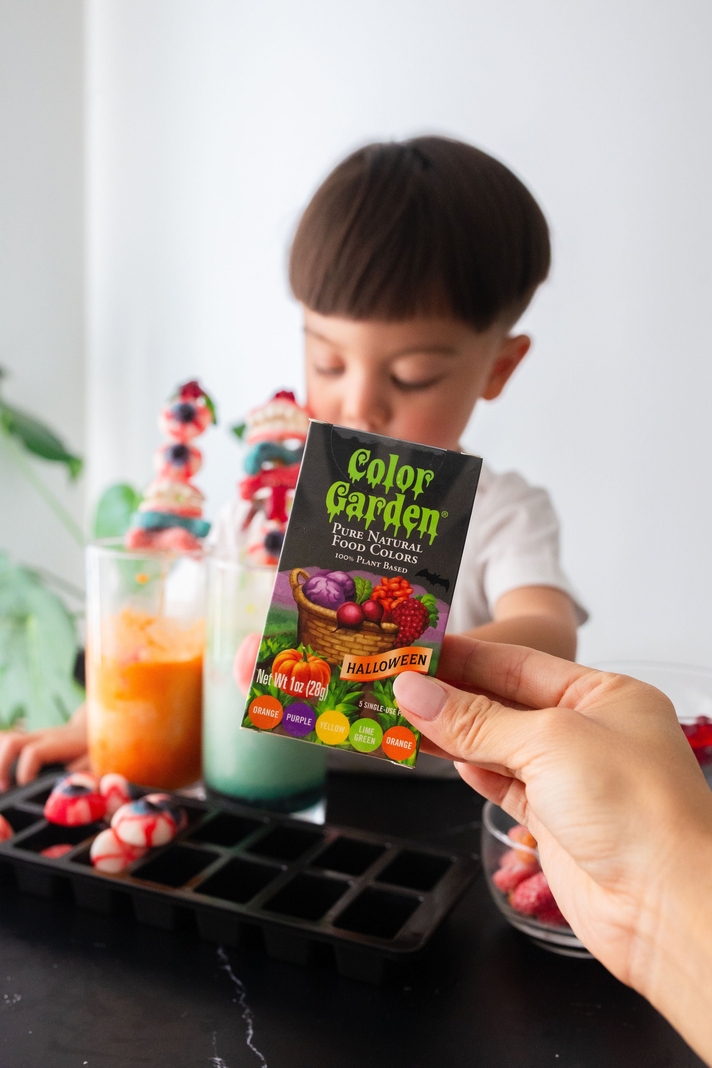 hand holding box of Halloween food colors