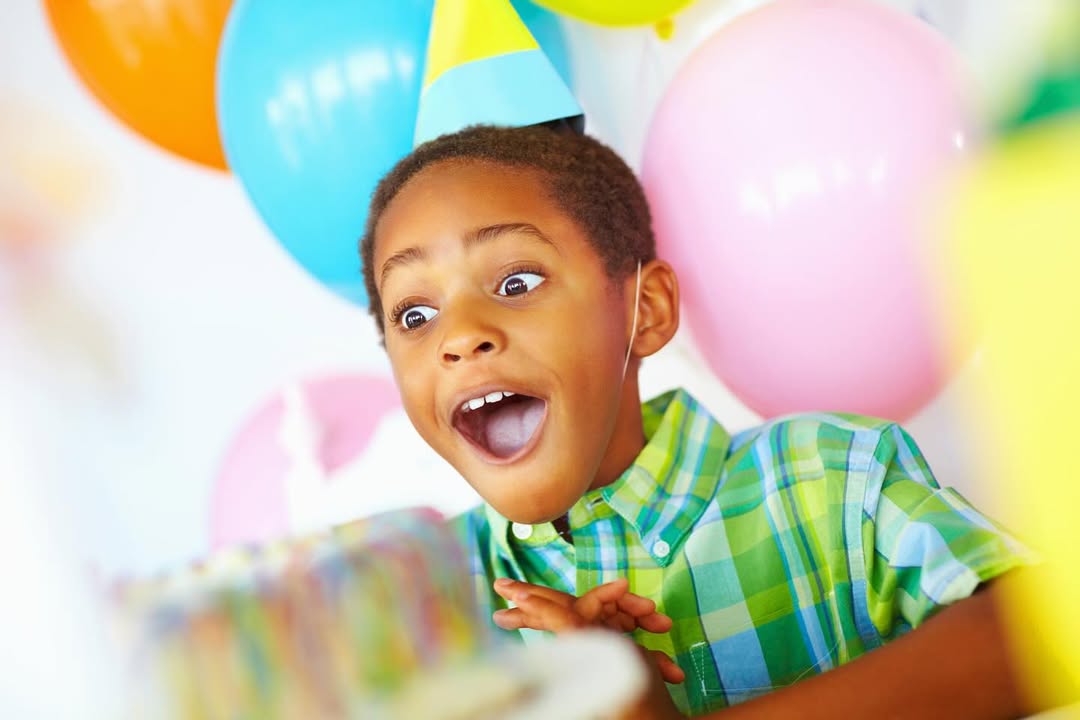boy smiling with birthday cake