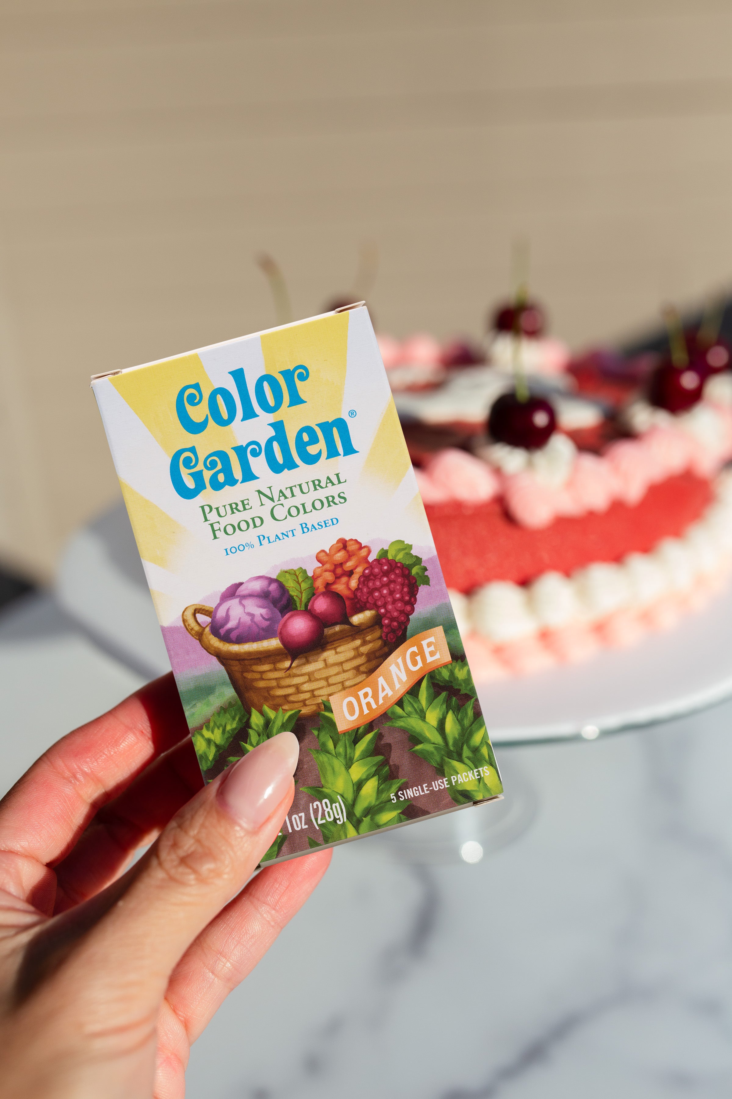 hand holding box of color garden orange food color